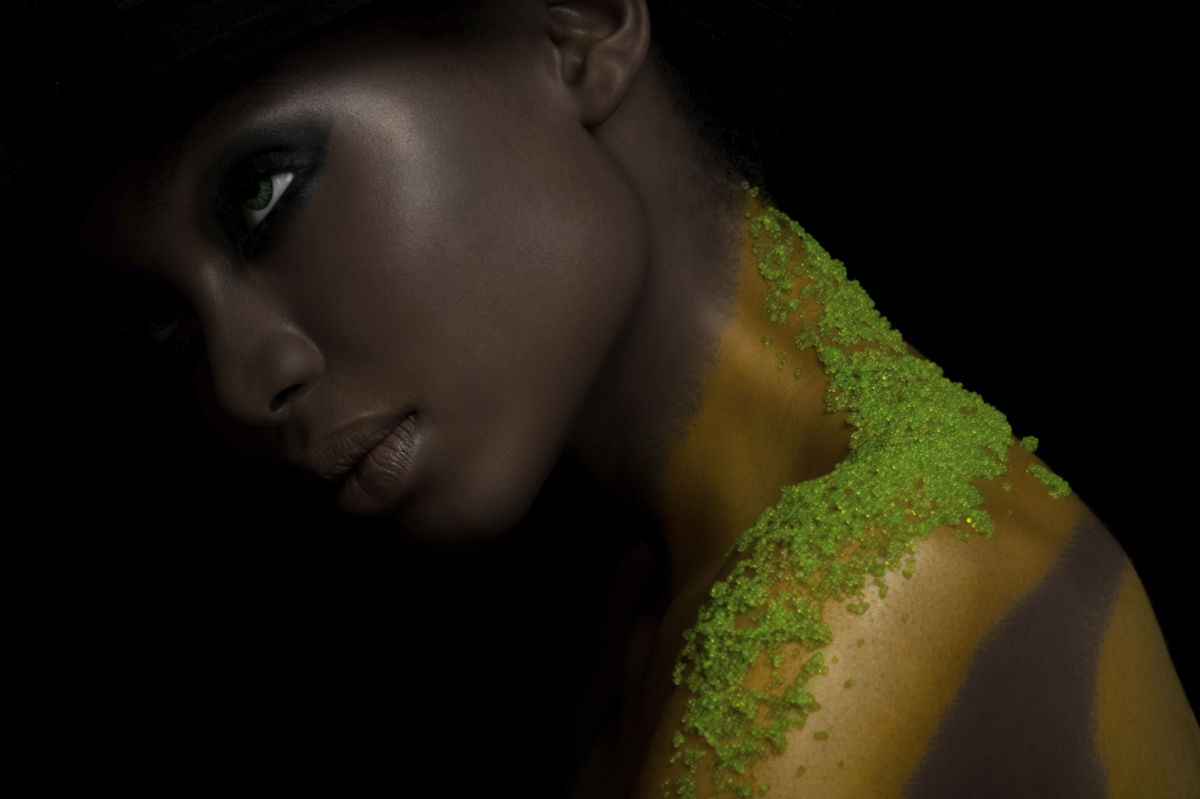 Fashion model with green caviar from Japanese flying fish on her shoulder.