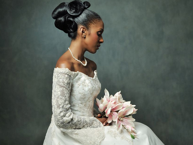 Junior Green seated bridal model with bouquet