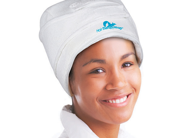 Model wearing hair therapy heat cap